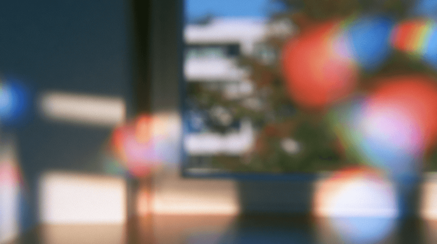 Soft-focus office with colorful lights by a bright window